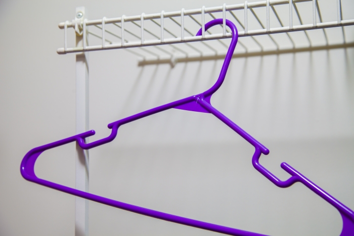 A hanger in an empty closet